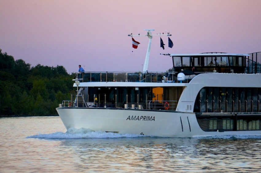 AmaPrima under a pink dusk sky on the Danube, approaching Vienna.