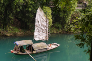 Traditional yacht boat along scenic river in Three Gorges