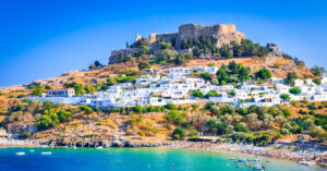 Rhodes, Greece. Lindos small whitewashed village and the Acropolis, scenery of Rhodos Island at Aegean Sea.