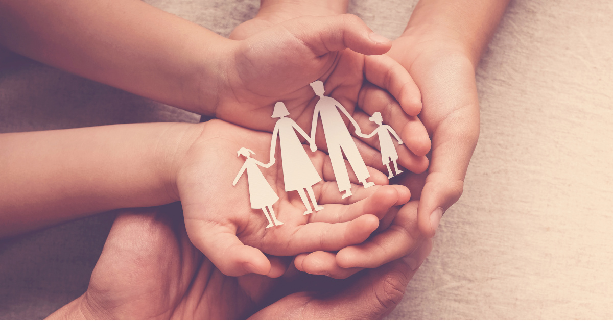 Adult and children hands holding paper family cutout, family home, foster care, homeless support concept