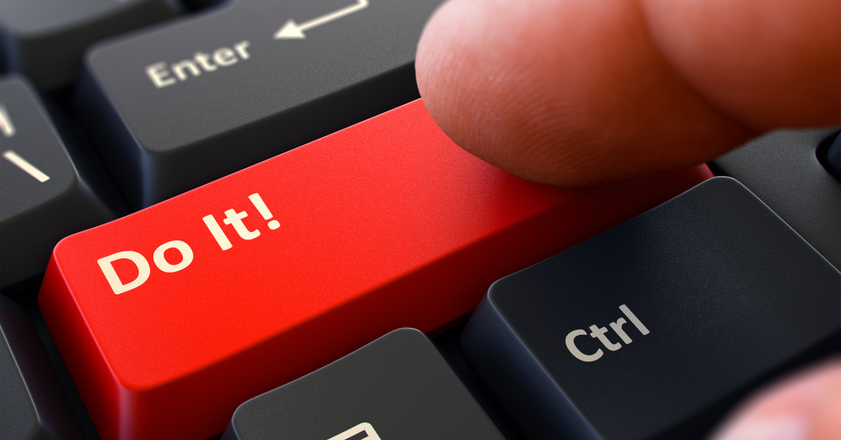 One Finger Presses Red Button Do It on Black Computer Keyboard. Closeup View. Selective Focus.