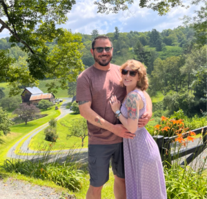 Justin Hinkle with wife, lush greenery in background