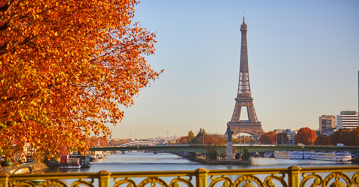 Scenic view of the Eiffel tower over the river Seine from Mirabeau bridge on a bright fall day in Paris, France