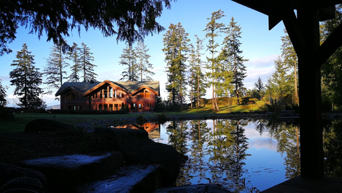 Wooden house on lake forest all around