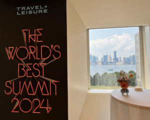 Sign with text "The World's Best Summit 2024" with window 