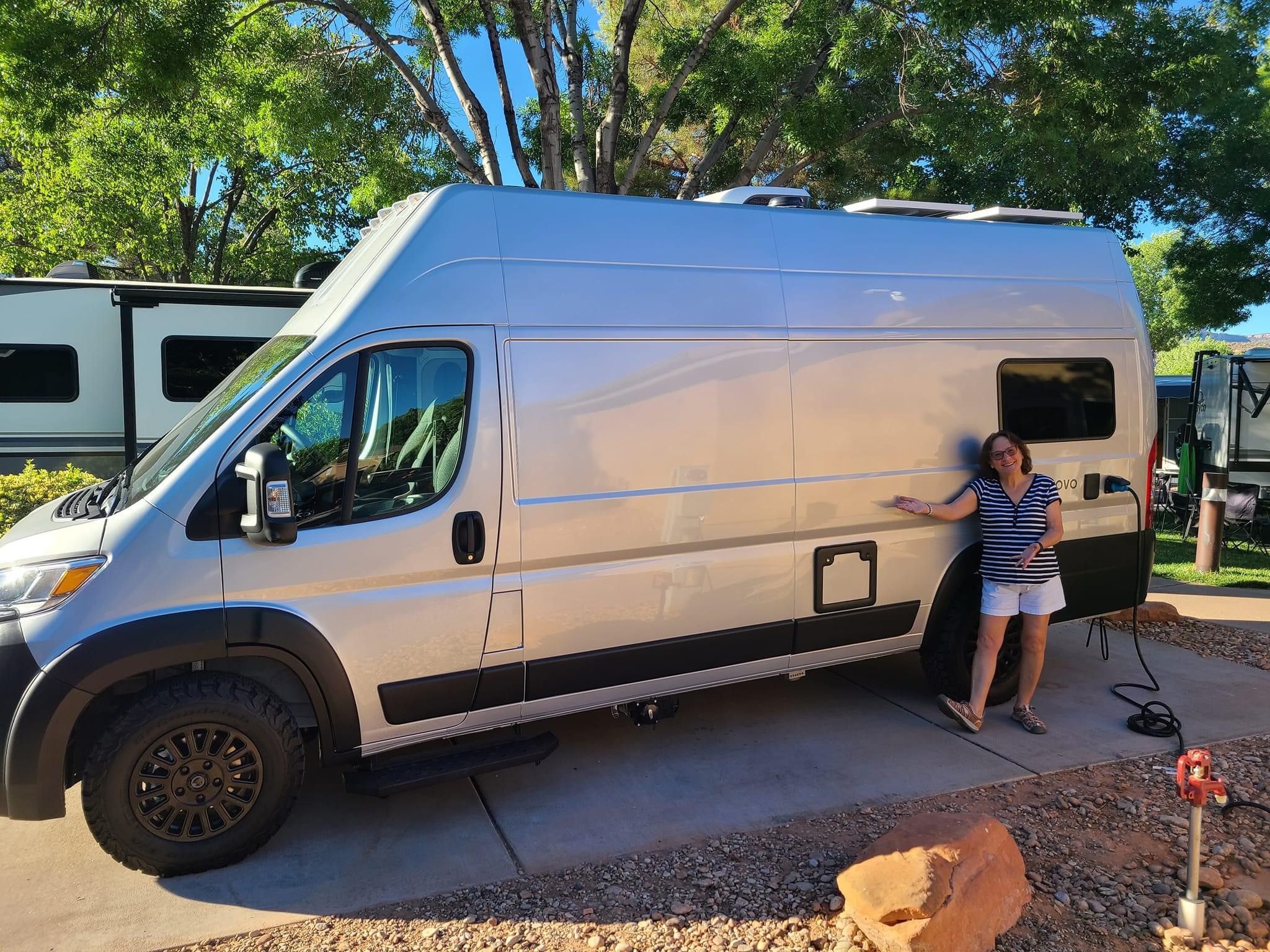 Cheryl Rosen posing in front of camper van at campground