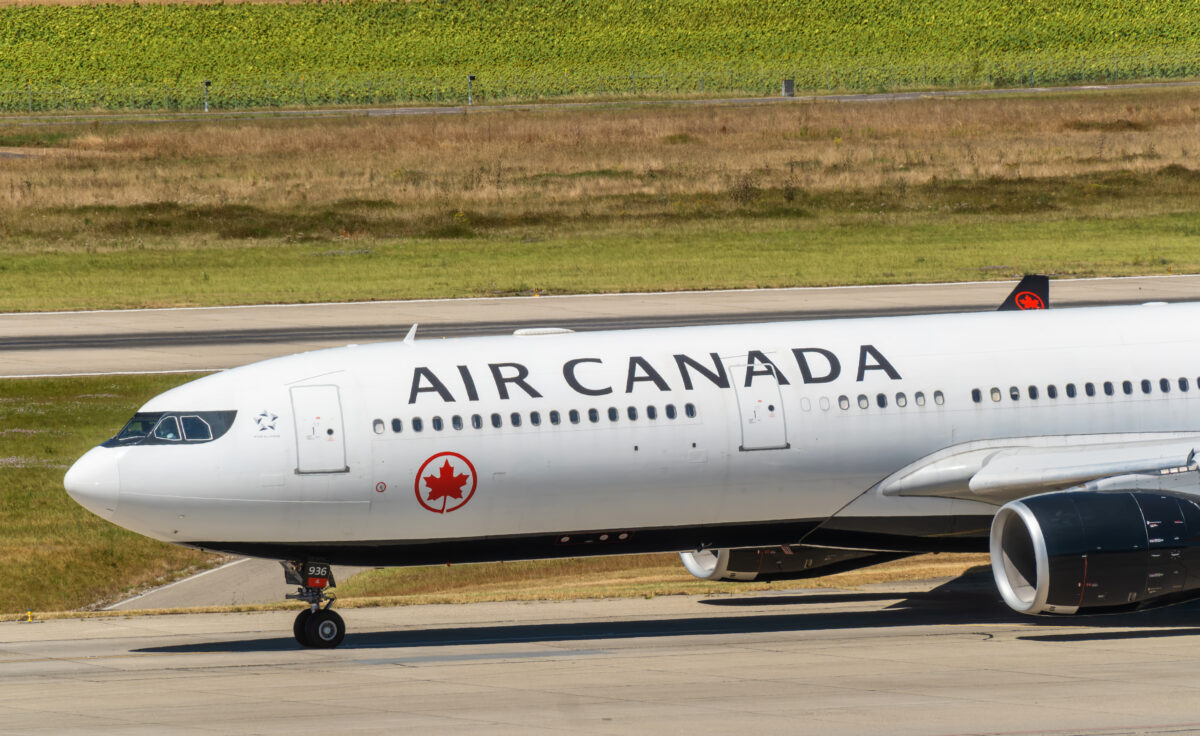 Geneva, switzerland - august 13, 2024: sign and logo on an airbus a330 - 300 airplane of air canada on the runway of geneva airport,