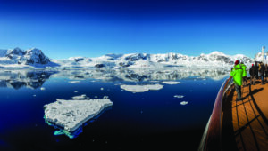 World Voyager in Antartica with bow and people on board.