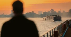 Sunset wit cruise ship and silhouette of person